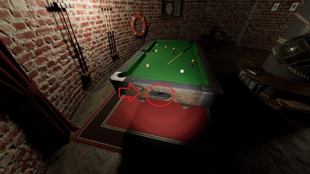 Phasmophobie : une table de billard avec une flèche rouge et un cercle indiquant l'endroit où une clé est sortie.