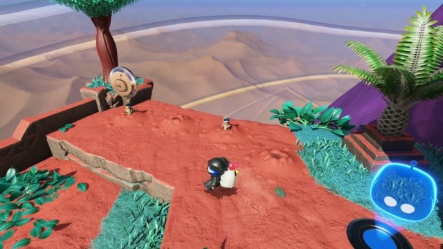 Astro Bot regarde deux chiens de prairie où un robot est caché.